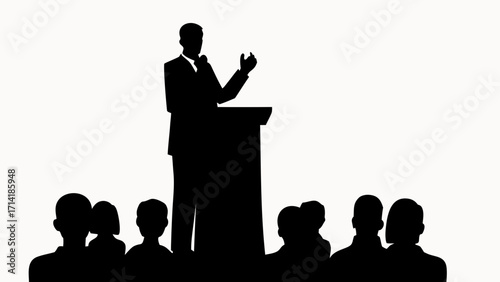 Silhouette of a speaker at a podium addressing an audience in a formal setting with a white background