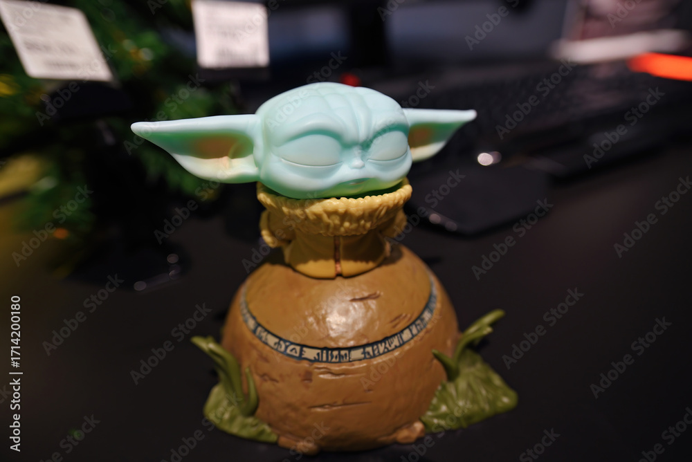 Obraz premium Minsk, Belarus. Jan 12, 2025. Yoda figurine, the child or baby Yoda fictional character from the TV series The Mandalorian, green toy inspired by the famous sci-fi saga Star Wars. Selective focus
