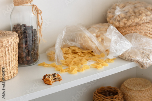 Unorganized storage of cereals in the kitchen cabinet  in sack bags, mess in the kitchen on the shelf for kitchen utensils