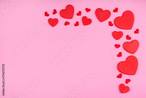 Valentine day pink greeting card background with red hearts