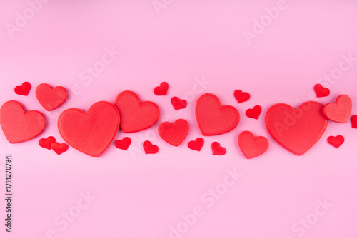 Valentine day pink greeting card background with red hearts