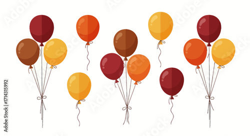 A festive collection of party balloons in warm autumn colors of red orange yellow and brown arranged in bunches and singles.