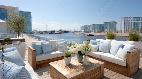 Scenic Rooftop Garden With Modern Outdoor Furniture On Wooden Deck Overlooking Blue Harbor And Distant Buildings Under Bright Sky