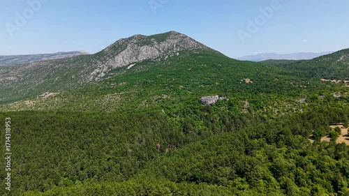 Breathtaking aerial video of the rugged limestone summit of Mount Svilaja rising above a vast green forest