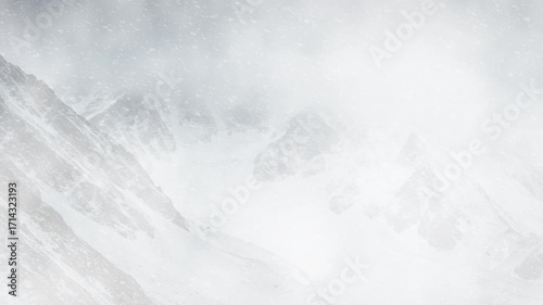 Snow Covered Mountain Peaks in Heavy Winter Storm, Misty Snowy Mountains with Dense Winter Clouds
