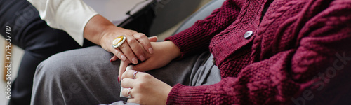 Bilde på lerret Header of woman comforting young adult woman by holding hands, both seated close