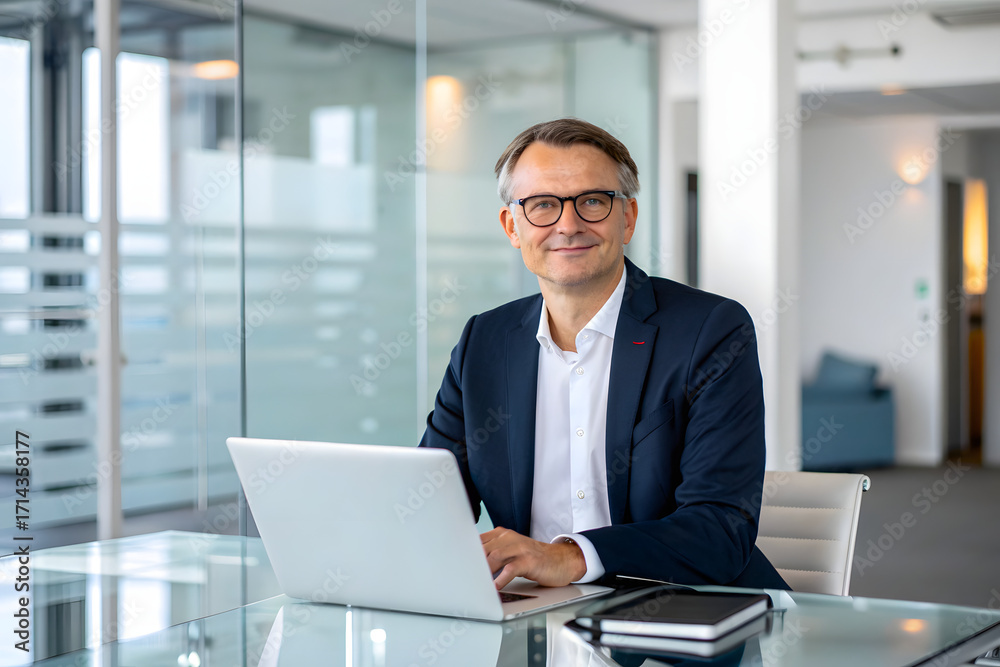Fototapeta premium Mature businessman working on laptop in office