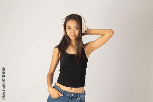Young woman in headphones and jeans