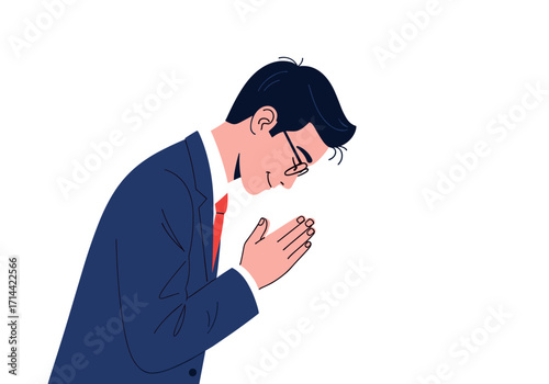 Man in suit bowing with hands together.