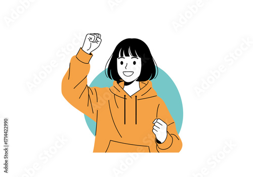 Young woman celebrating success with fist pump and smile.