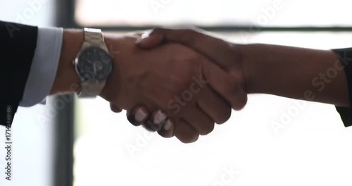 Wallpaper Mural Business professionals shaking hands in a modern office Torontodigital.ca