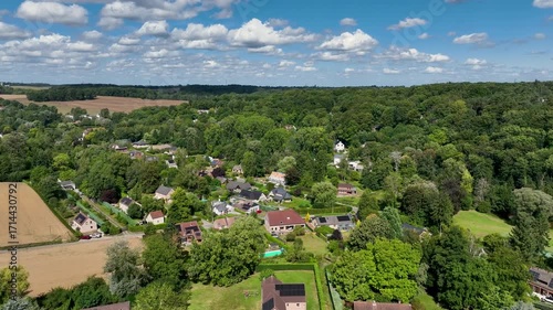 Aerial view of Genappe municipality and city of Wallonia located in the Belgian province of Walloon Brabant. Villas with garden surrounded by forest.