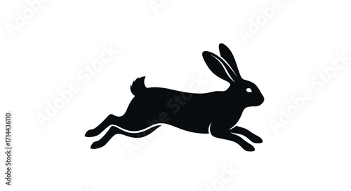 Silhouette of a black rabbit in mid-leap, showcasing its ears, tail, and legs against a white background.