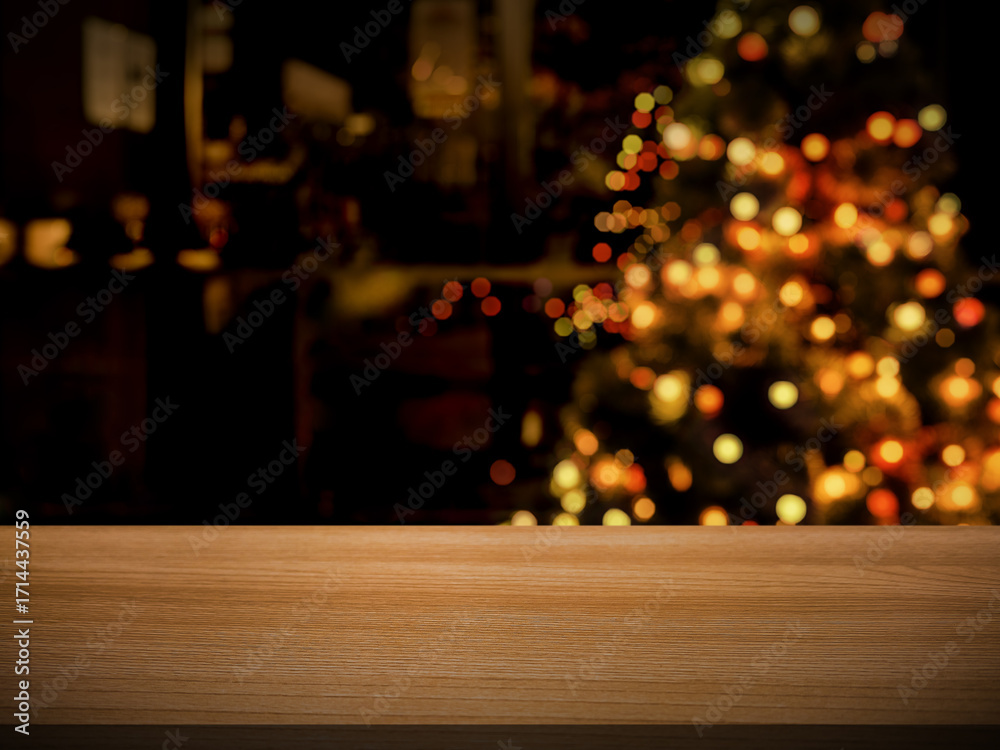 Fototapeta premium Empty wooden table on celebration night The background is a blur of Christmas trees and restaurants.