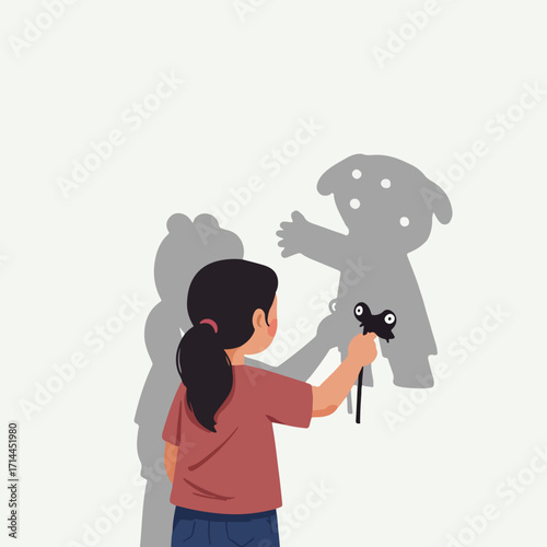 Child creates shadow puppets on wall using a toy, casting playful and imaginative shadows
