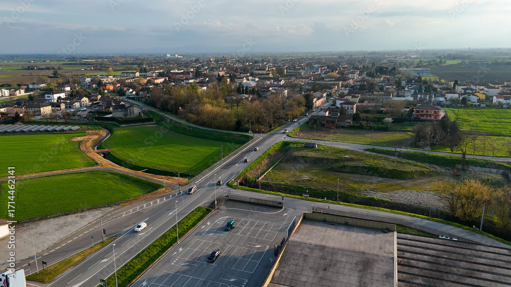 Fototapeta premium Panoramic aerial view of Castelvetro Piacentino and surrounding countryside with SS 10 highway and agricultural fields in the Piacenza region of Italy captured on a clear day