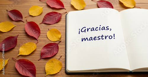 Open notebook with Spanish gratitude surrounded by autumn leaves