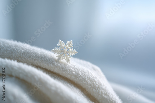 delicate snowflake resting on cozy mitten against softly blurred white background