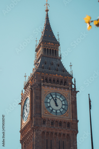 Majestic big ben clock tower against blue sky and white clouds, a symbol of london and england