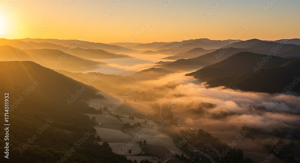 Naklejka premium Sunrise over mountainous landscape with misty valleys and golden light