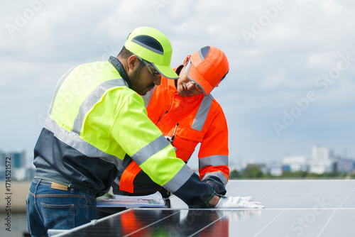 Engineers installing solar panels on rooftop for clean energy