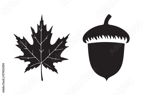 Black silhouette of a maple leaf and an acorn