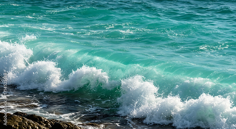 Fototapeta premium Turquoise ocean waves crashing against rocky shoreline