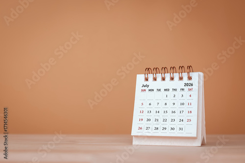 Calendar page July of the year 2026 on orange background. with copy space and business design. Concept of monthly planning, important schedules, meetings, and appointments.