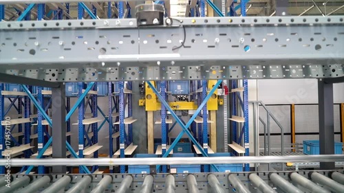 Automated Conveyor Belt System Sorting Blue Containers in Modern Warehouse Logistics Facility