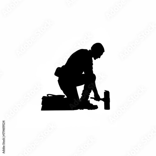 Silhouette of a construction finisher with an edging tool isolated on white background