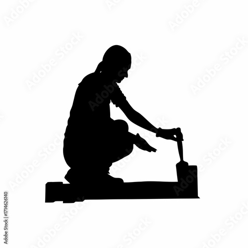 Silhouette of construction worker crouching near curb finishing edges isolated on white background