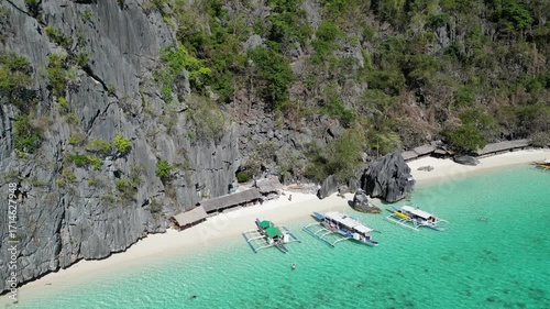 Coron, Palawa, Philippines, in South East Asia, with White Sand Beach, Turquoise Water, filmed on an Island island hopping boat tour with Limestone Cliffs in the background