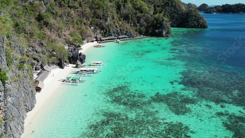 Coron, Palawa, Philippines, in South East Asia, with White Sand Beach, Turquoise Water, filmed on an Island island hopping boat tour with Limestone Cliffs in the background