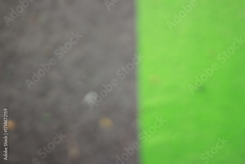 A dreamy view of neon green paint on the asphalt.