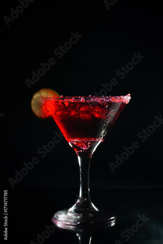 Cocktail, red alcoholic drink isolated on black background