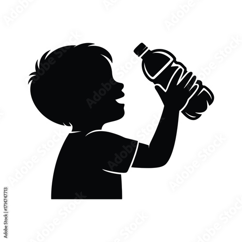 Silhouette of a happy young boy holding a water bottle and drinking