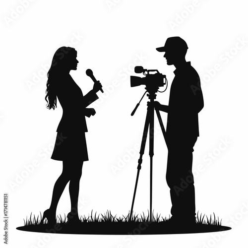 Silhouette of a female reporter interviewing a cameraman with a video camera on a tripod