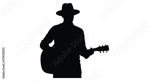Silhouette of a musician playing an acoustic guitar wearing a hat