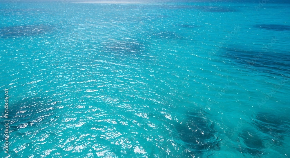 Fototapeta premium Crystal Clear Turquoise Ocean Water with Gentle Waves and Sunlight Reflections