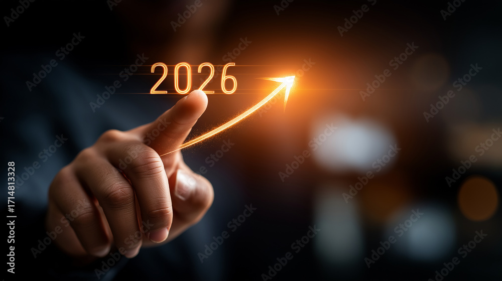 Obraz premium Determined leader hands touching 2026 with target arrow hologram representing new year business goals and success roadmap on dark background. business goals 2026 strategic vision