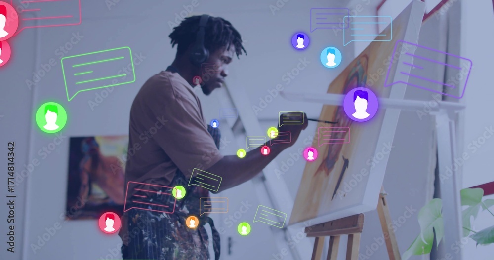 Naklejka premium Artist in splattered apron and headset painting canvas on easel in art studio with speech bubbles