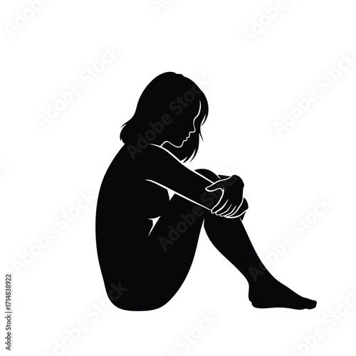 A solitary figure head in hands displaying a poignant emotional silhouette