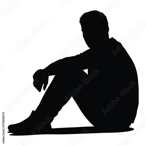 A solitary figure seated in a contemplative pose dark silhouette