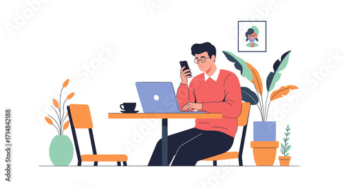 A man in a red sweater sitting at a table using his phone and laptop while working in a cafe.