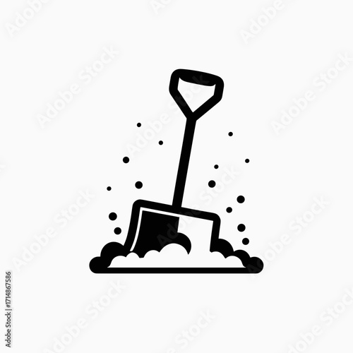 Shovel digs snow and snowflakes fly through the air