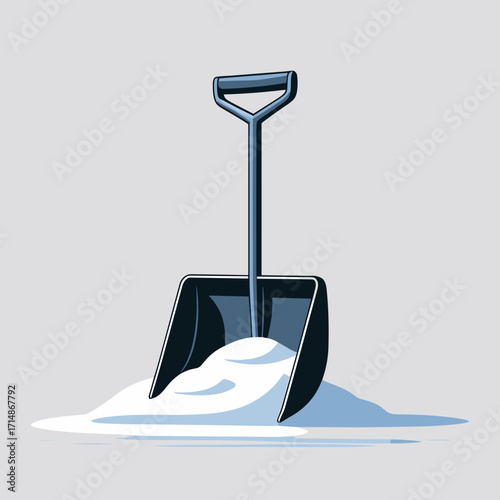 Snow shovel resting on a pile of snow on a gray background  