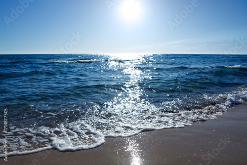 Sandy beach with blue sky and turquoise water ,as holiday summer background.