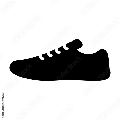 Silhouette of casual sneaker shoe icon-Black silhouette illustration of a low-top sneaker shoe with laces, simple flat design isolated on white background for fashion or sports.