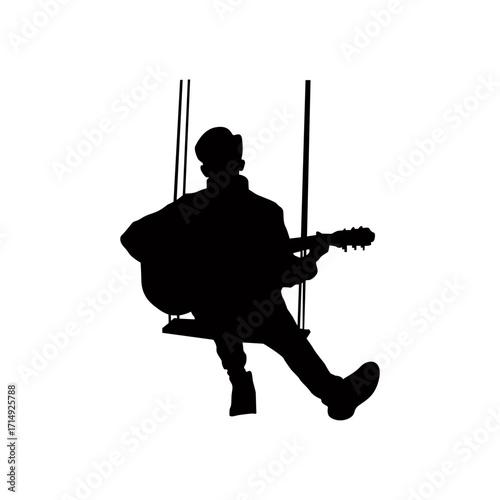 A captivating silhouette of a man sitting on a swing and playing an acoustic guitar.