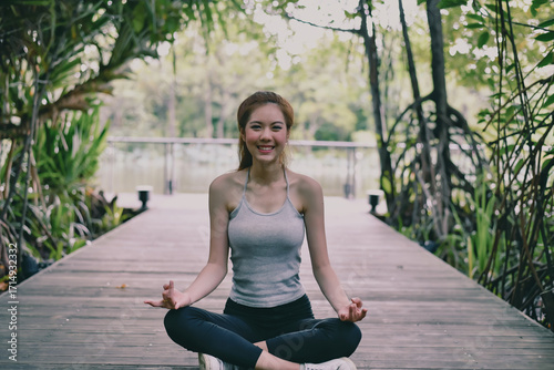 Wallpaper Mural A serene moment of meditation by a young woman in nature, embracing relaxation and mindfulness. Torontodigital.ca